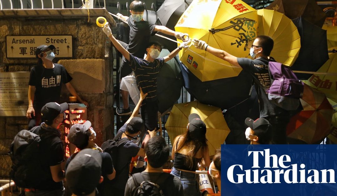 Hong Kong protesters hold noisy rally outside police headquarters